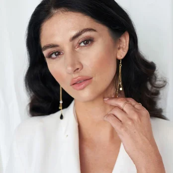 Woman with smooth, youthful skin touching face showcasing natural beauty and facial contouring results
