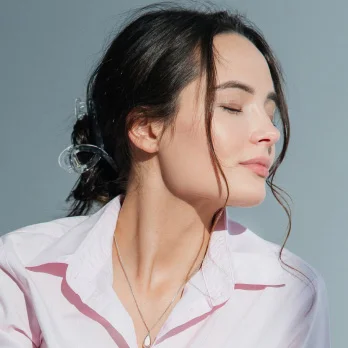 Woman with smooth skin profile showing neck and jawline after scar revision treatment