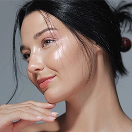 Woman with dewy glowing skin and natural makeup showcasing healthy skincare routine results