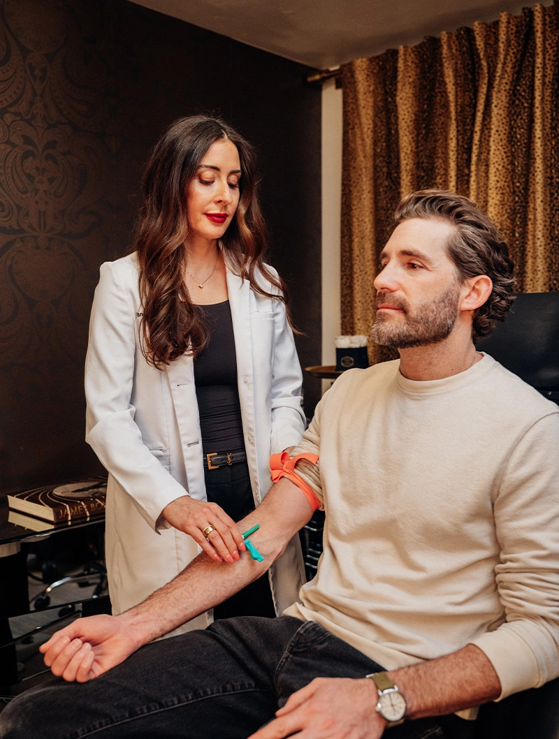 Skincare professional examining client's arm during Biologique Recherche consultation in luxury spa setting - IV Therapy in Bend, OR
